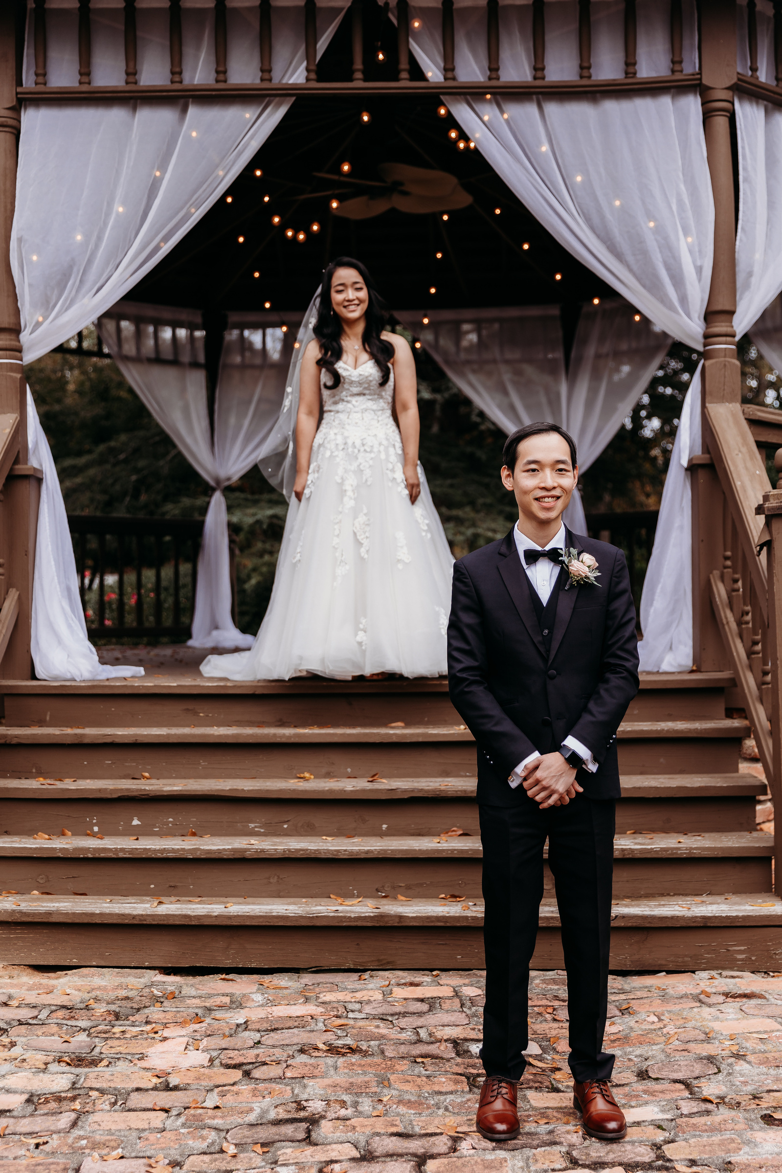 bride standing behind groom before their first look