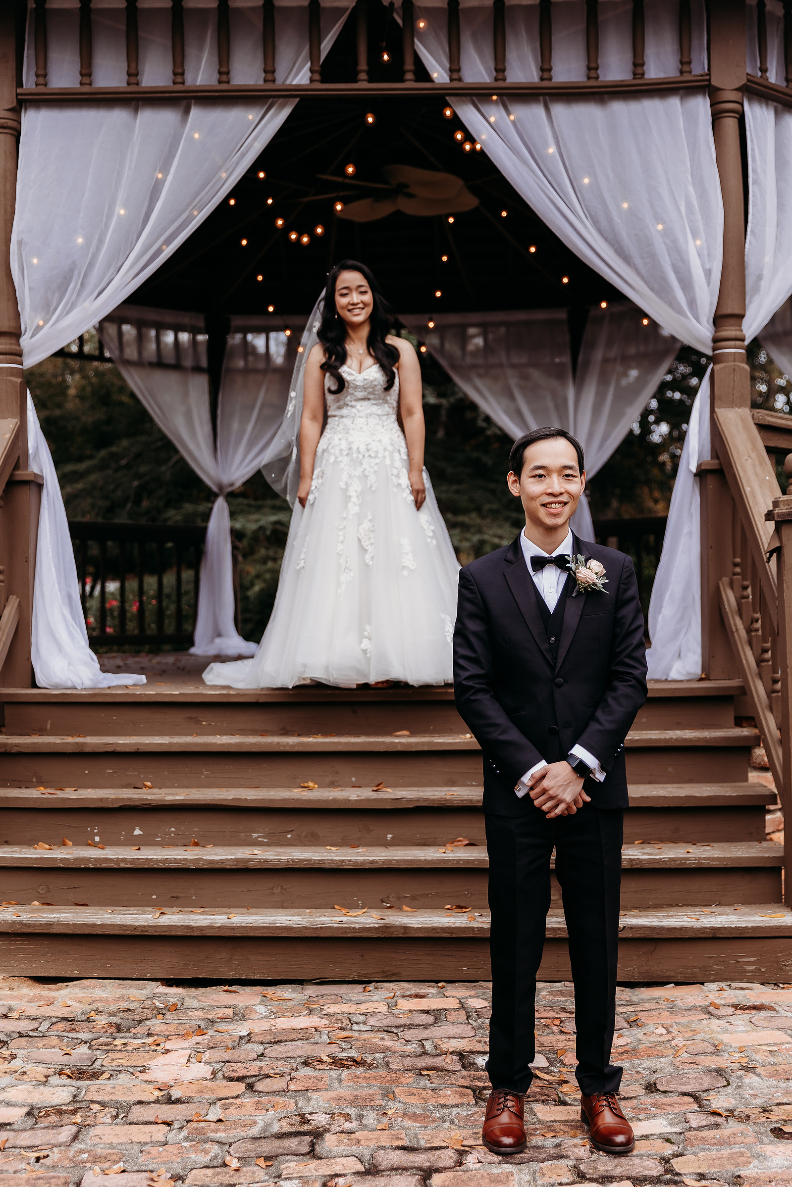 bride standing behind groom before their first look