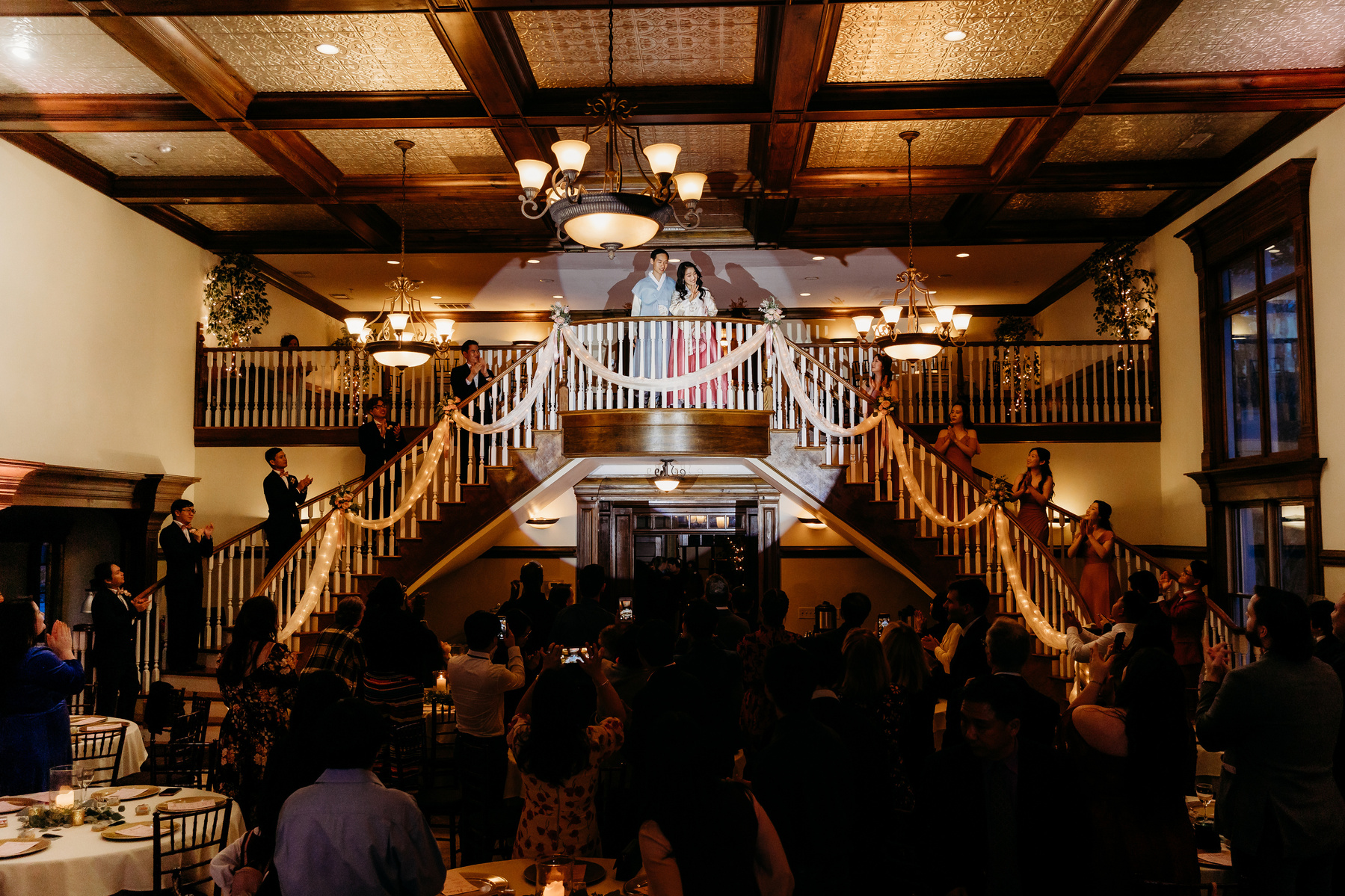 bride and groom enter reception with a spotlight on them 