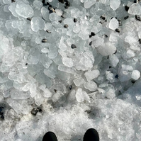 view of shoes, looking down at icy terrain