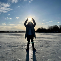 frozen lake on the mountain, sun in the background