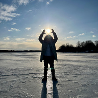 frozen lake on the mountain, sun in the background
