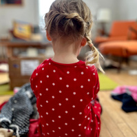 ella opening a package with hair by oma