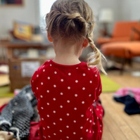 ella opening a package with hair by oma