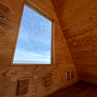 a framed view from triangular sitting hut