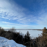 view of frozen lake from higher ground
