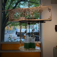 Poorna: Simulations of the whole, Propeller Gallery, 2024. Spirulina, thrifted vases, bubbler, donated rubber motor, MDF, local poplar wood, scrap metal, acrylic sheet, plumbing parts, Delrin, bolts, Metal rods on loan from metal studio, tears, patience. 