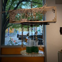 Poorna: Simulations of the whole, Propeller Gallery, 2024. Spirulina, thrifted vases, bubbler, donated rubber motor, MDF, local poplar wood, scrap metal, acrylic sheet, plumbing parts, Delrin, bolts, Metal rods on loan from metal studio, tears, patience. 