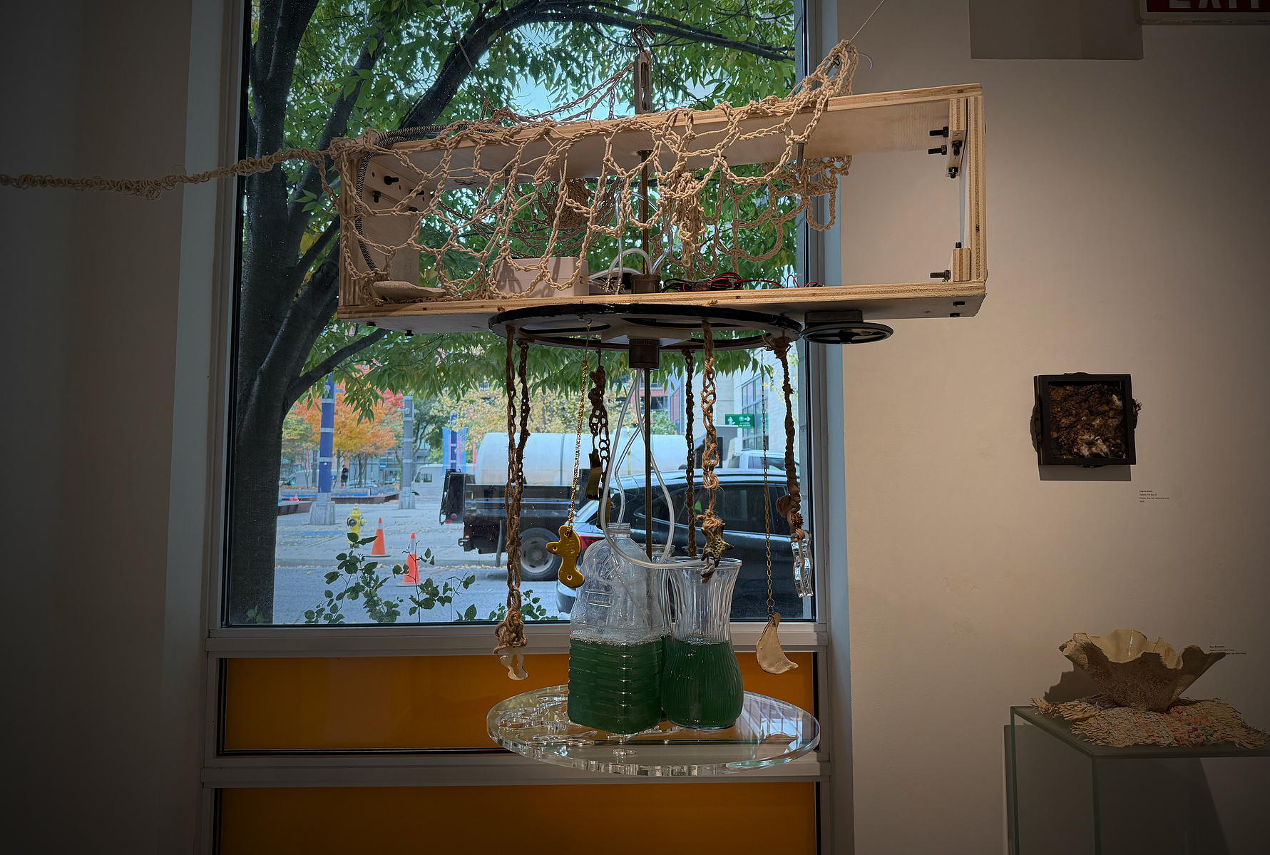 Poorna: Simulations of the whole, Propeller Gallery, 2024. Spirulina, thrifted vases, bubbler, donated rubber motor, MDF, local poplar wood, scrap metal, acrylic sheet, plumbing parts, Delrin, bolts, Metal rods on loan from metal studio, tears, patience. 