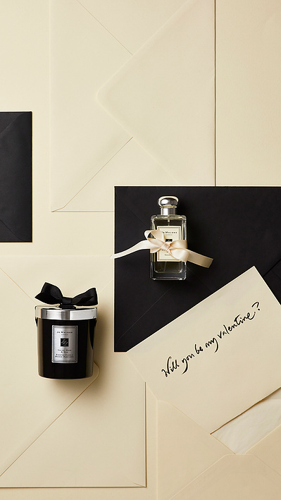A romantic composition capturing two perfume bottles from a top-down perspective, withThis emotionally engaging image is skillfully photographed by David Lineton, an expert in perfume advertising photography in London. 