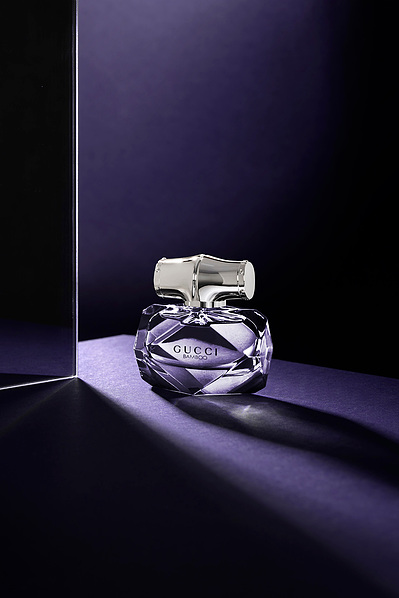 A captivating top-down view capturing an open, round perfume bottle. This elegant composition is skillfully photographed by David Lineton, an expert in fragrance photoshoot in London.