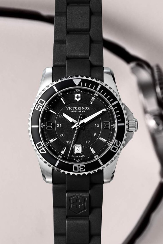 Victorinox watch with a rubber strap, a black edition and a monochrome blurred watch face behind the macro close-up of the watch. Feature for Esquire Big Watch Book 2022