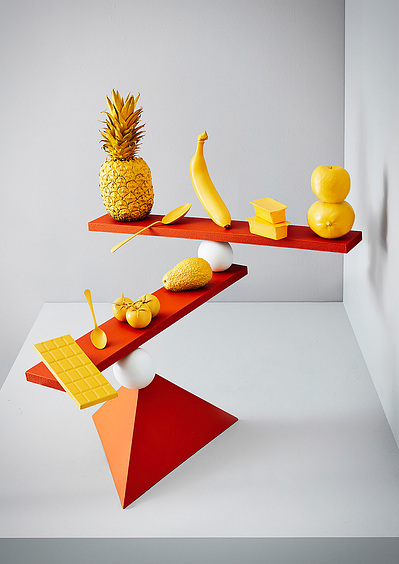 A compelling scene capturing fallen fruits on the ground alongside a juicer machine and its jug. This evocative still life photograph is expertly crafted by David Lineton, a specialist in still life photography in London