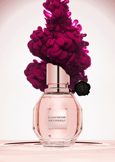 A visually enchanting presentation showcasing Flowerbomb perfume, adorned with a top cover adorned with delicate flowers. This captivating image is skillfully captured by David Lineton, an expert in perfume commercial photography in London. 