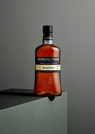 An enticing composition featuring a Highland Park bottle placed on a surface with half of the bottle extending beyond the edge. This visually intriguing image is skillfully photographed by David Lineton, an expert drinks advertising photographer in London