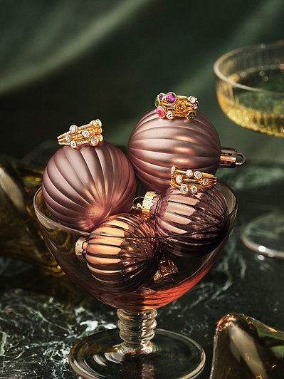 A beautifully composed photograph capturing pieces of jewelry placed elegantly within a glass. This visually appealing scene is skillfully photographed by David Lineton, an expert in jewelry product photography in London
