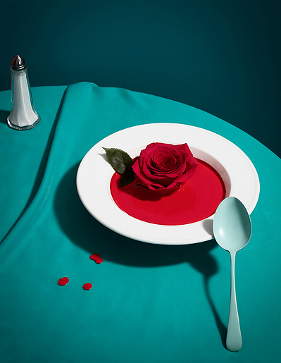 A visually striking composition featuring a cut hand placed in a plate, surrounded by vegetable leaves. This captivating image is skillfully captured by David Lineton, a modern still life photographer in London