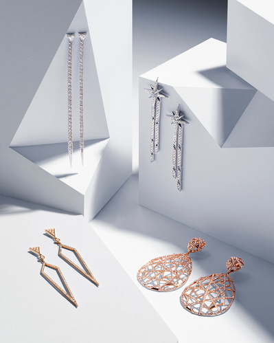 An artful display featuring different pieces of jewelry creatively arranged.  This visually captivating composition is skillfully photographed by David Lineton, an expert in jewelry product photography