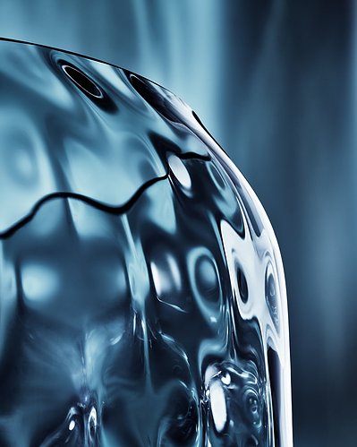 A close-up view of a light black-colored surface of a glass portion against a similar light black-colored background. This meticulously composed image is expertly captured by David Lineton, a specialist in still life object photography in London.