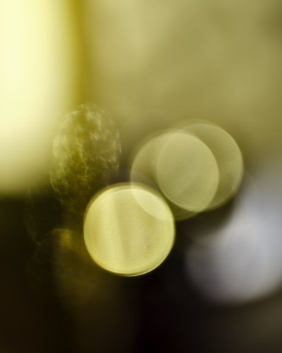 A close-up view capturing three round circles appearing in yellow against a darkish background. This precisely composed image is expertly captured by David Lineton, a specialist in still life object photography in London