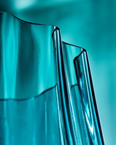A beautifully composed bluish-colored view of a glass set against a bluish surrounding and background. This aesthetically pleasing still life photograph is expertly captured by David Lineton, a specialist in still life object photography in London
