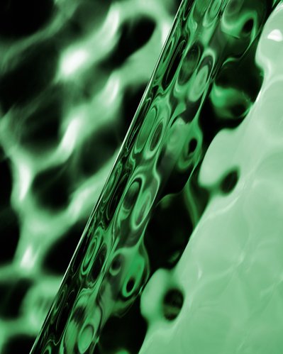 A close-up view highlighting the unique greenish color surface of a glass against a matching background. This intricately composed image is expertly captured by David Lineton, a specialist in still life object photography in London.