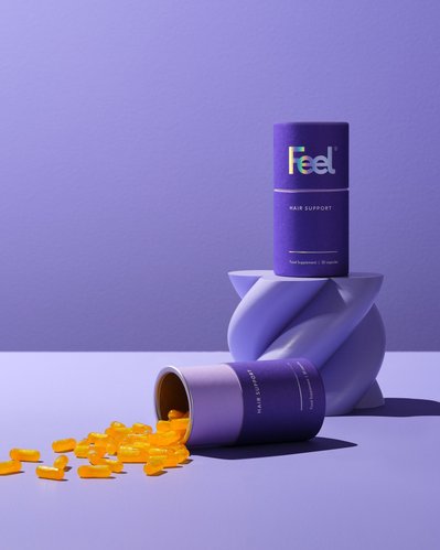 A visually engaging composition featuring two Hair Support supplement products. This artfully arranged image is skillfully photographed by David Lineton, an expert still-life photographer in London. 