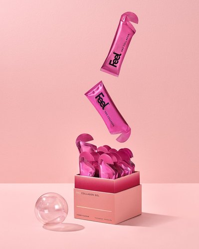 An enchanting arrangement capturing a complete box of Feel beauty products, nearly filled to the brim.. A delicate ball completes the scene. This visually appealing presentation is skillfully photographed by David Lineton, an expert in London makeup still