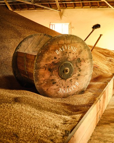 The Balvenie Distillery tour in Dufftown, Inverness Scotland. Maltings process with golden sunset lighting.