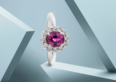 A stunning composition showcasing a white ring adorned with a prominent purple pearl at its center. this visually captivating arrangement is skillfully photographed by David Lineton, an expert in luxury product photography in London