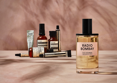 A visually dynamic arrangement featuring multiple cosmetics products placed on a surface, with some positioned vertically and others horizontally. Photographed by David Lineton, an expert in London cosmetics photography. 