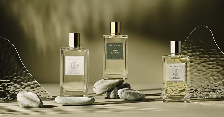 Ripples and earthy undertones of three Mizensir Fragrances and perfumes sitting in light shafts and water glass casting movement to the light.
