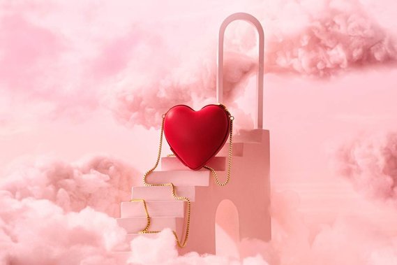 Stairway up to a Red heart-shaped product sitting in the clouds. Love is in the air. 