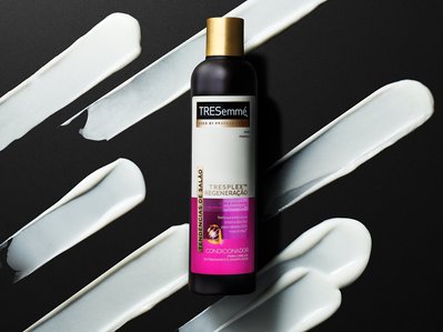 A sophisticated advertisement featuring a conditioner, artfully arranged on a black surface with precise white lining for a modern and luxurious presentation. This striking image is masterfully captured by David Lineton, a distinguished photographer.