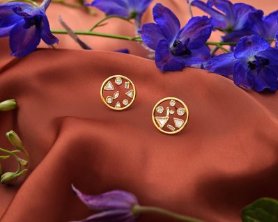 A picturesque composition featuring two pieces of jewelry delicately placed in between flowers. This visually enchanting scene is skillfully photographed by David Lineton, an expert in commercial jewelry photography in London.