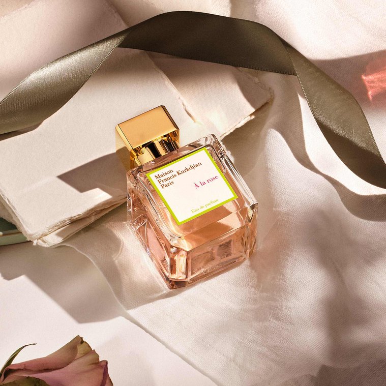 detail image of Maison Francis Kurkdijian sitting in dappled summer light. With a refraction glow coming from the perfume bottle