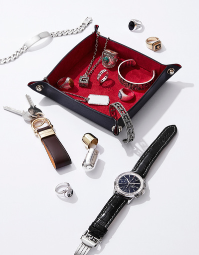 An organized composition with rings, a watch, a necklace, keys, and various pieces of jewelry. Photographed by David Lineton, an expert in luxury product photography in London