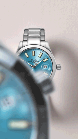 Motion edit of Ball Timepiece, an oyster blue watch face with glow-in-the-dark highlights and a dial framed by a macro movement that pans across the frame revealing the Stainless steel timepiece.