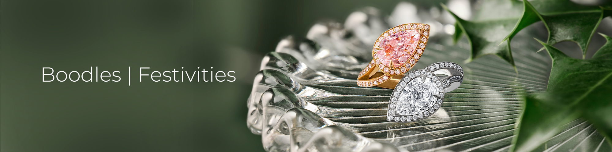 Boodles Jewellery Christmas Still Life, Gold and Platinum ring with pink and white diamond. Sitting in amoungst holly