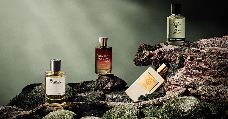 Frosty Green hues of mossy and earthy set built up like a cliff face. The Perfumes and Fragrances sit on branches and rocks. 