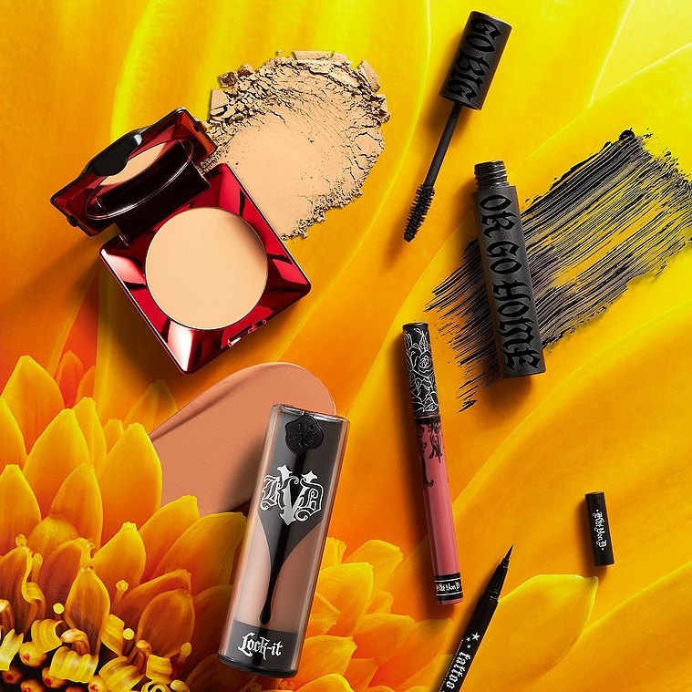 KVD Vegan Makeup and smudges photographed on vibrant flower leaves. With liquid foundation, powders and Mascara.