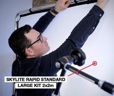 David Lineton adjusting a skylite Rapid scrim frame behind the scenes