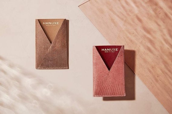 Honing into the small real leather Hanuxe wallets. A plaster background brings in a pinky hue with the shards of cut glass creating some striking refractions