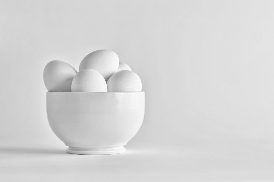 eggs in a white bowl on a minimal white background