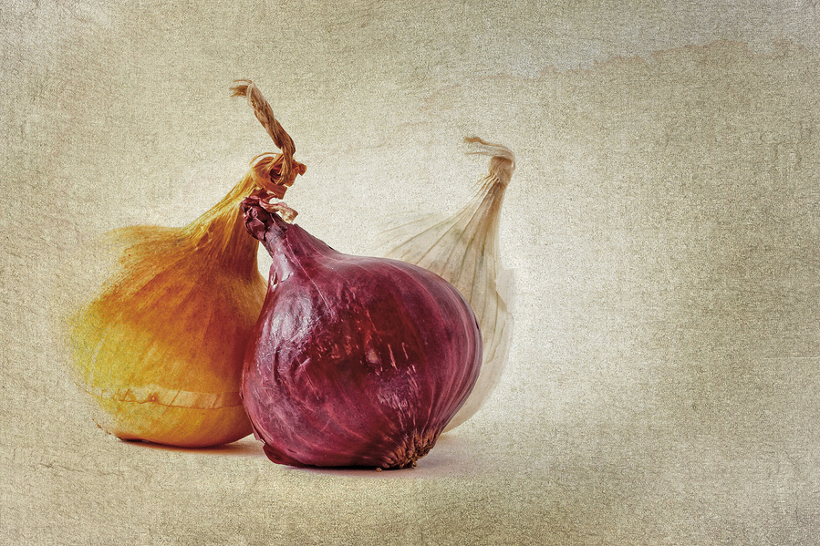red, yellow and white pearl onions overlaid with a texture