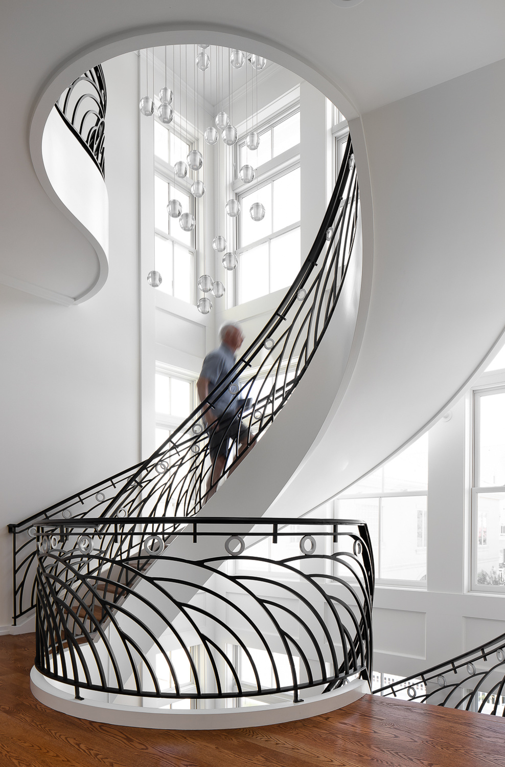 Man walking up a custom curved staircase in a Ventnor NJ boardwalk home