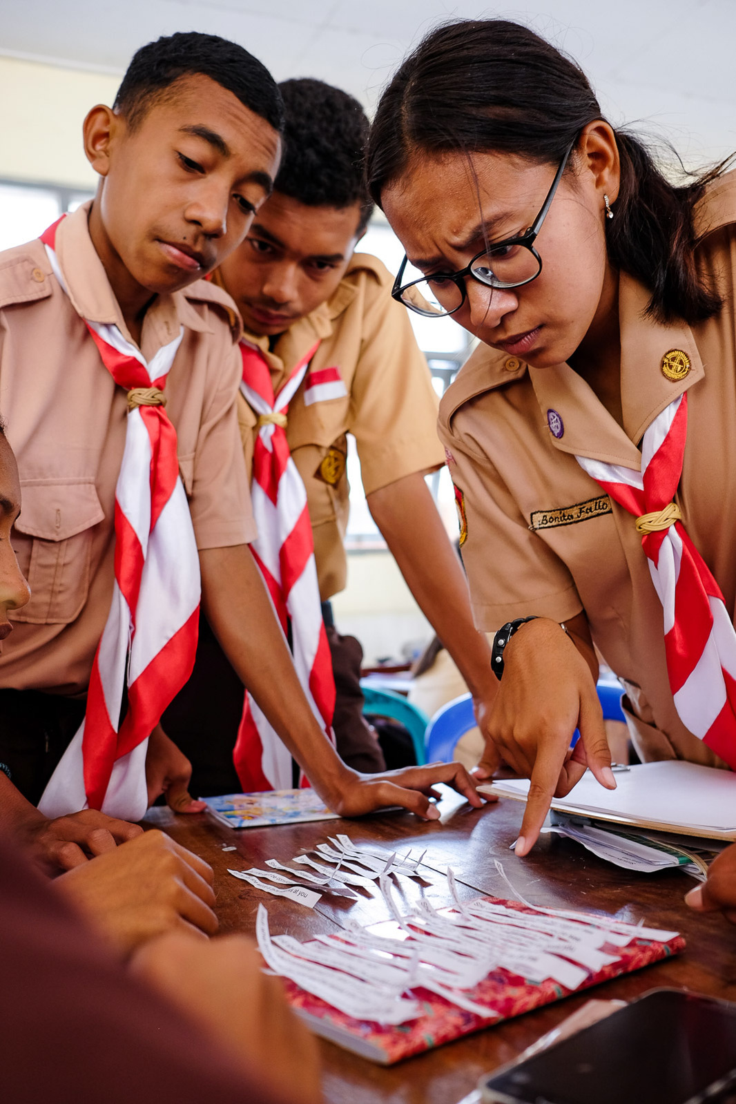 Sophomores Inho, Mario, and Bonita (left to right) unscramble the lyrics to Billy Joel's "She's Always A Woman" during their English class at SMAN 5 on October 3, 2020 in Kupang, Indonesia.
