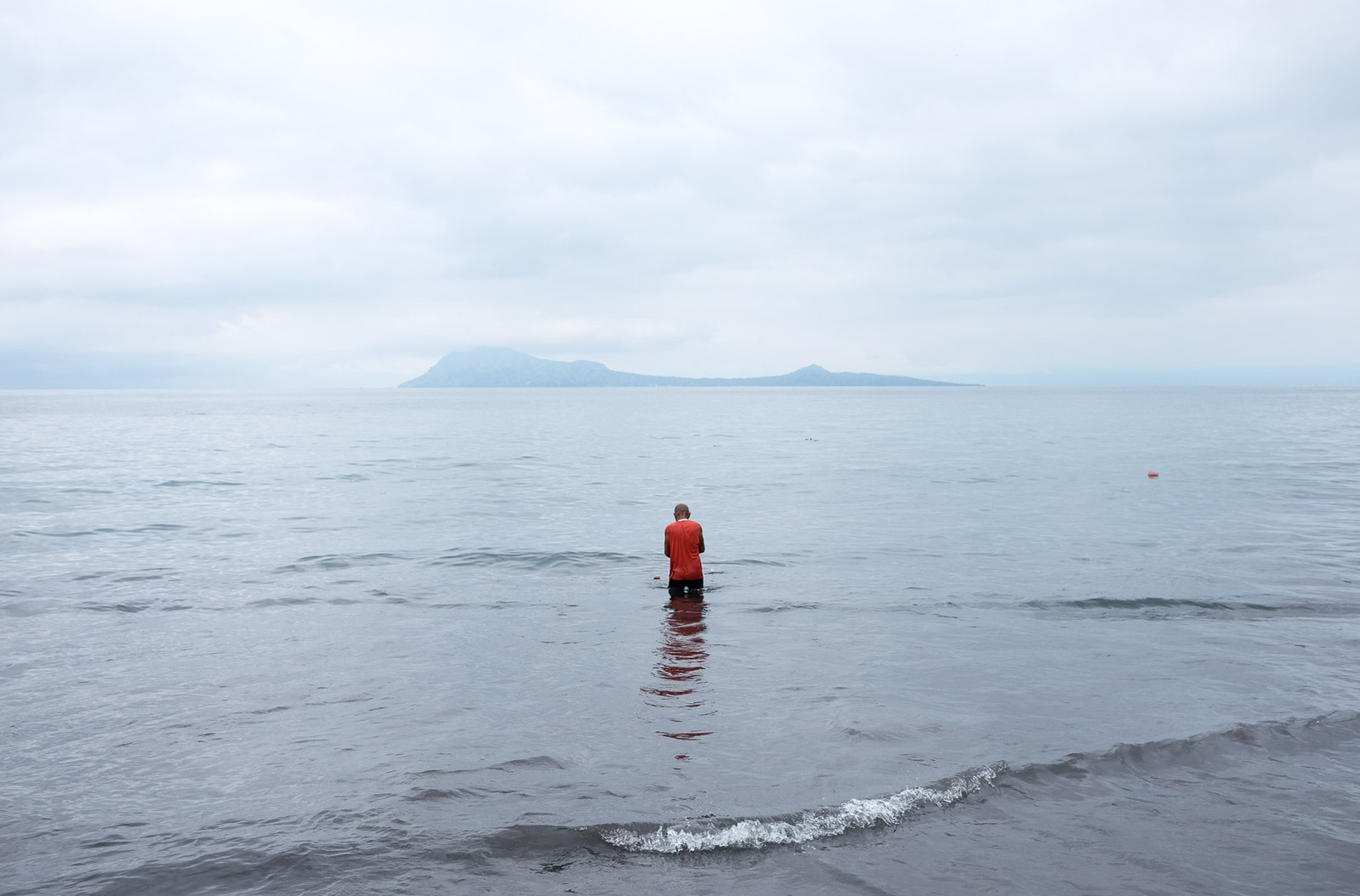 A fisherman wades into the Savu Sea on April 29, 2019 in Ende, Indonesia.
