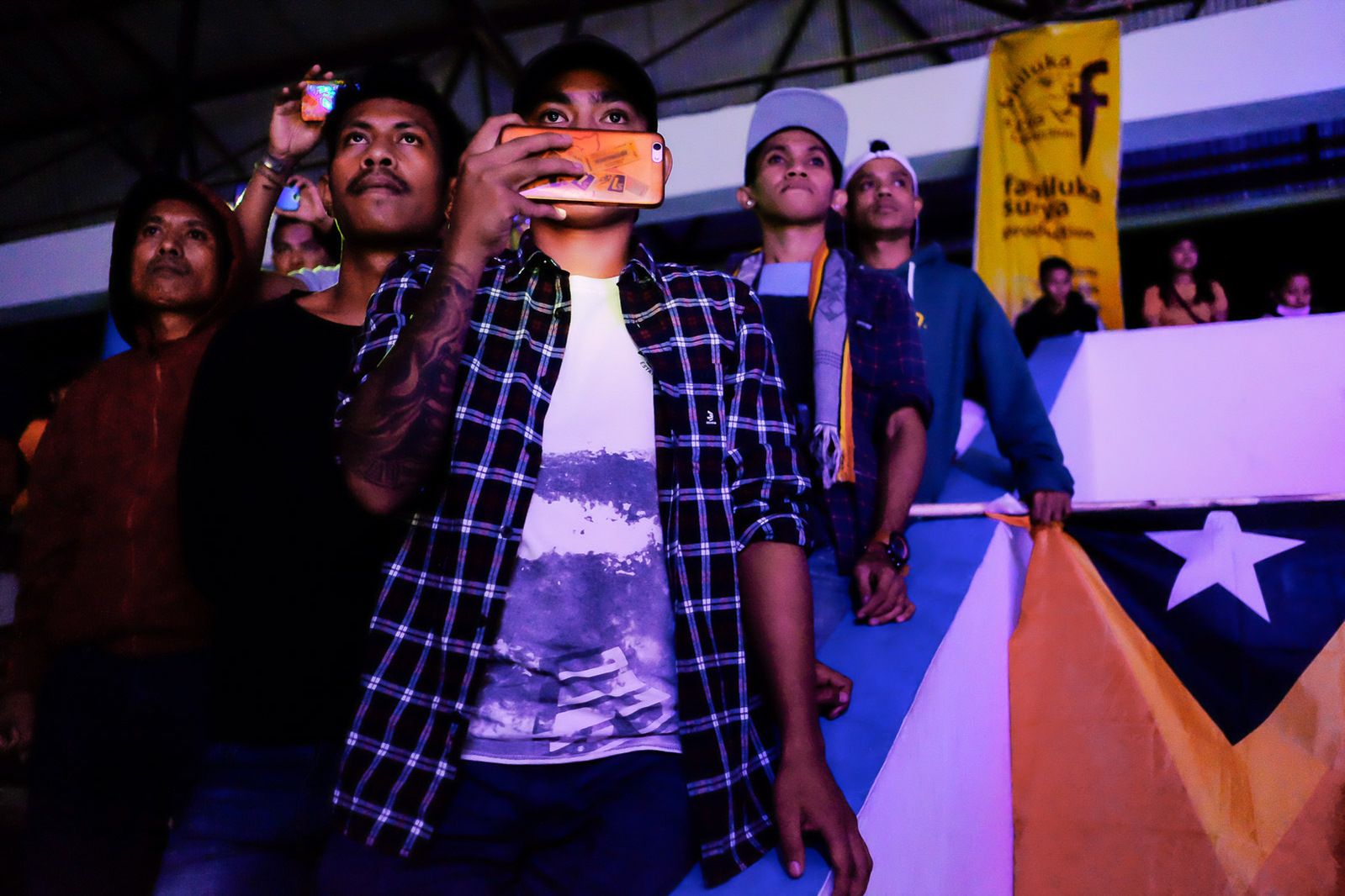 Supporters of East Timorese athletes look on during a boxing exhibition match on July 7, 2019 in Kupang, Indonesia.