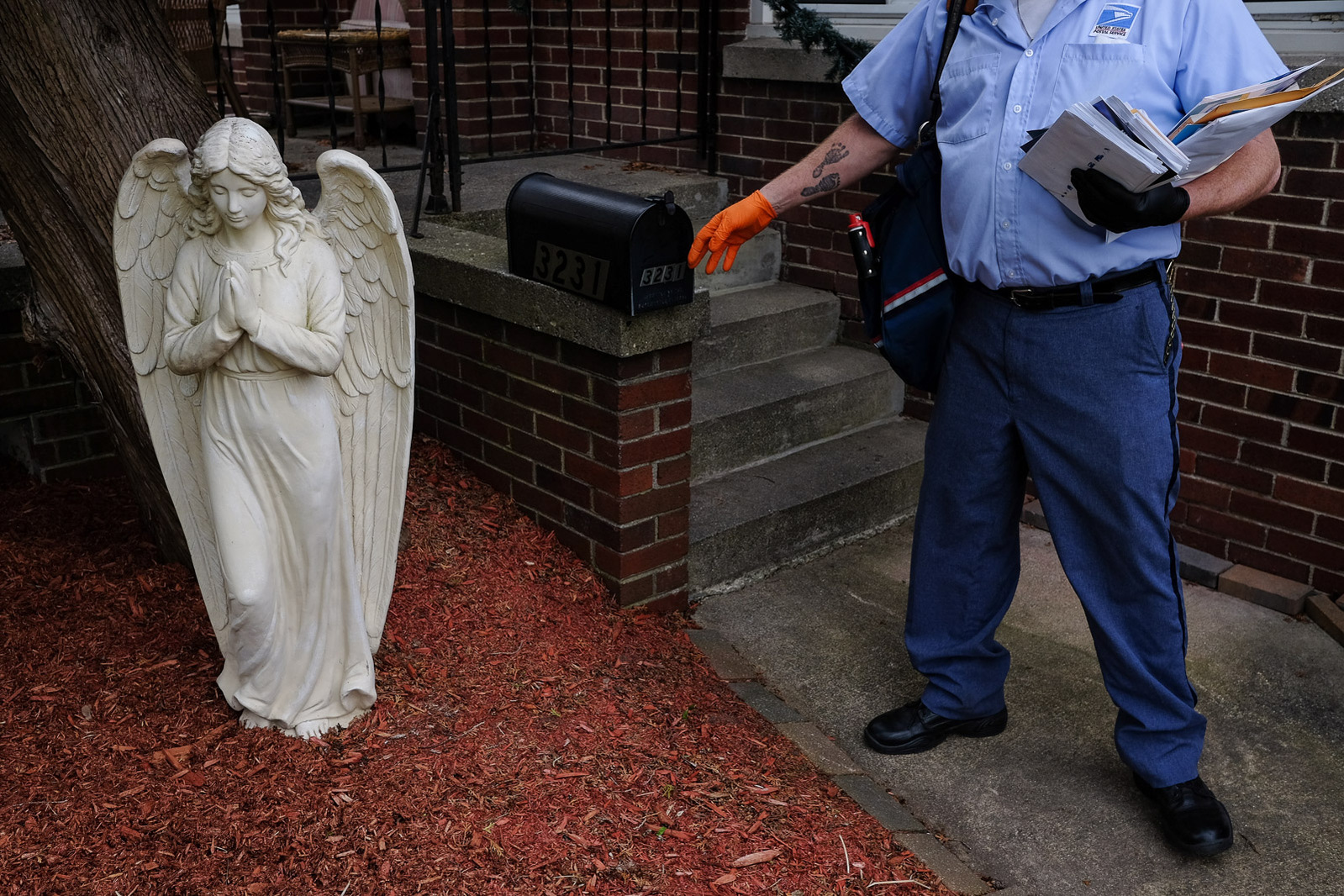 Mark Swan, a USPS letter carrier and President of the National Association of Letter Carrier’s 74th branch in Saginaw, delivers mail on foot on Saturday, April 25, 2020 in Carrollton Township, Mich.